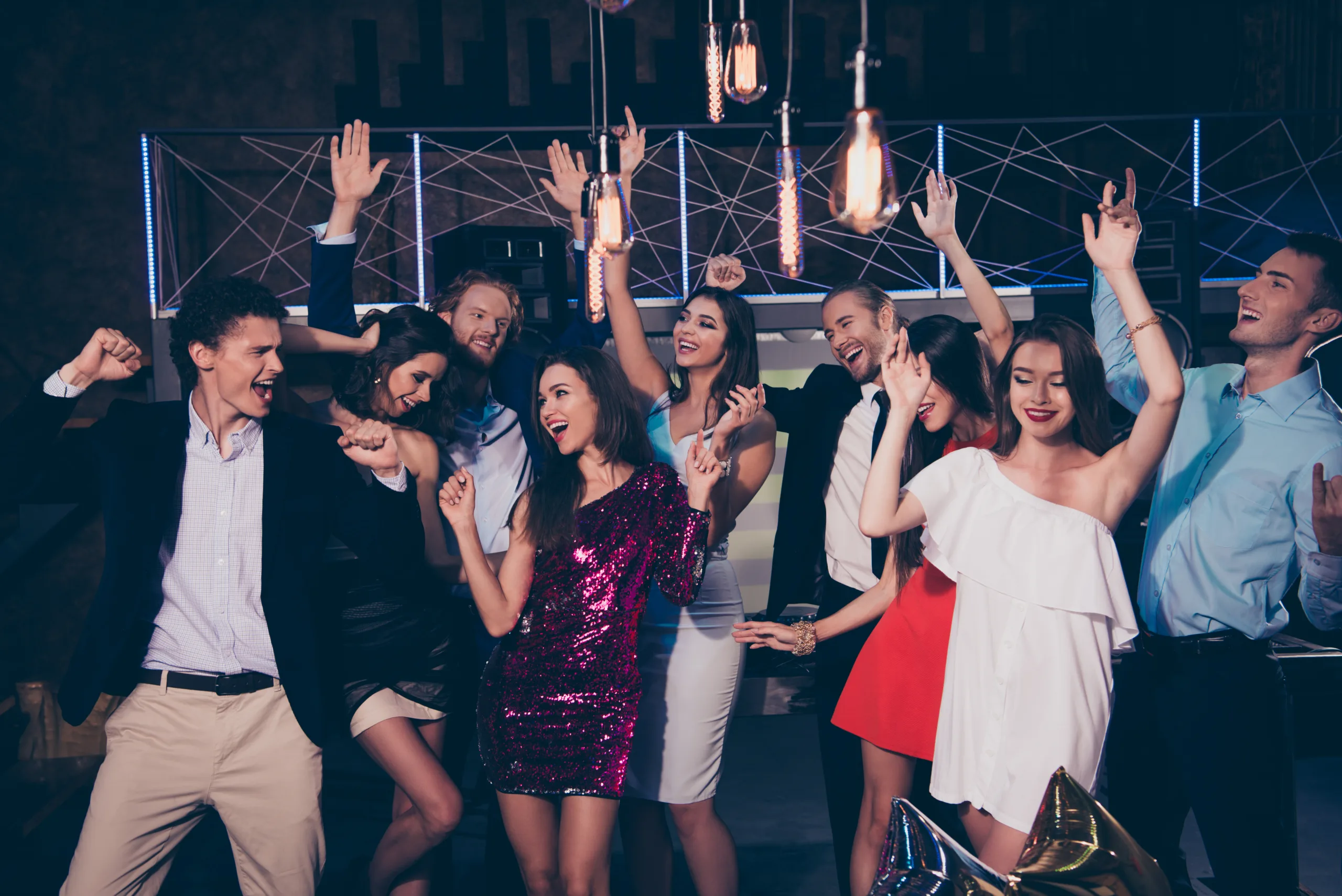 Group of people joyfully dancing in elegant attire at a vibrant event, ideal for promotional content on Tampa wedding and corporate event photography.