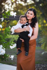 Happy family enjoying a sunny day outdoors in Spring Hill, Florida, surrounded by lush greenery and blooming flowers.