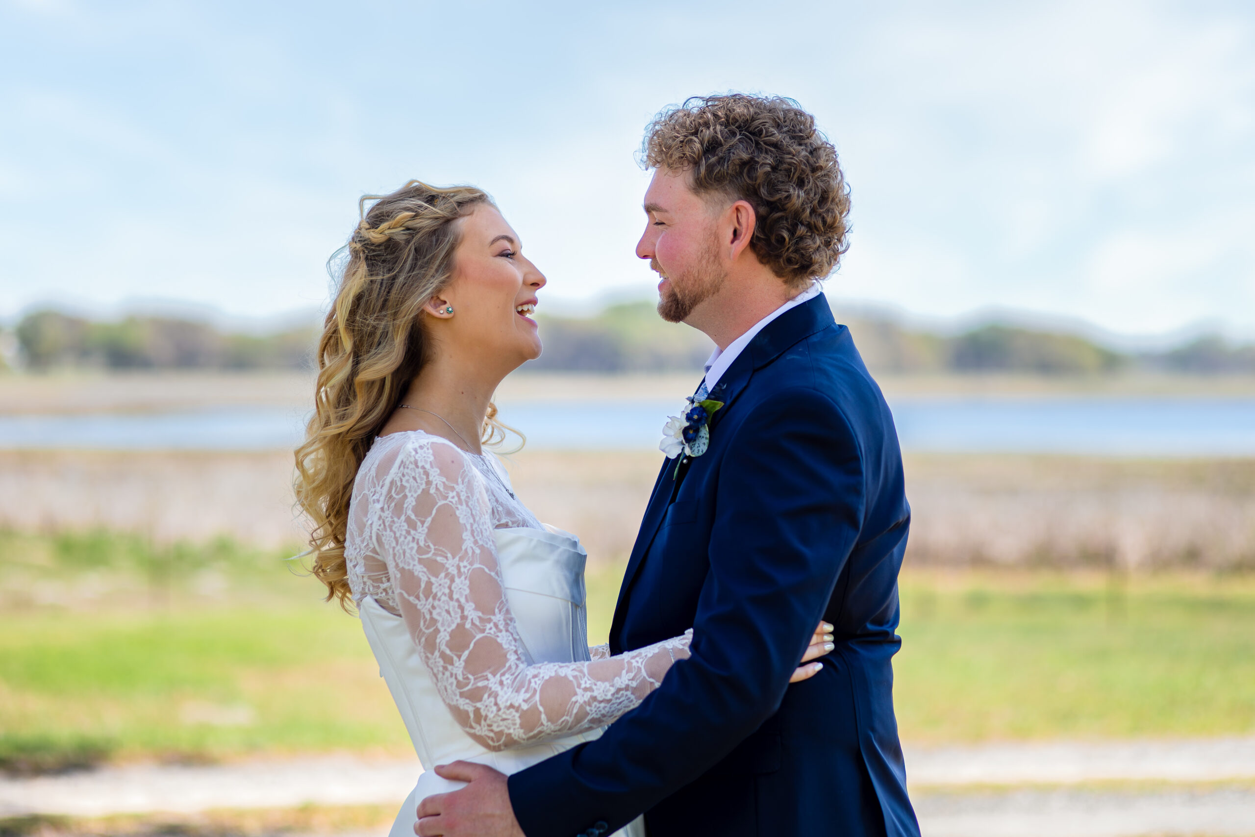 Bride and groom embracing during an outdoor Florida wedding photography session.